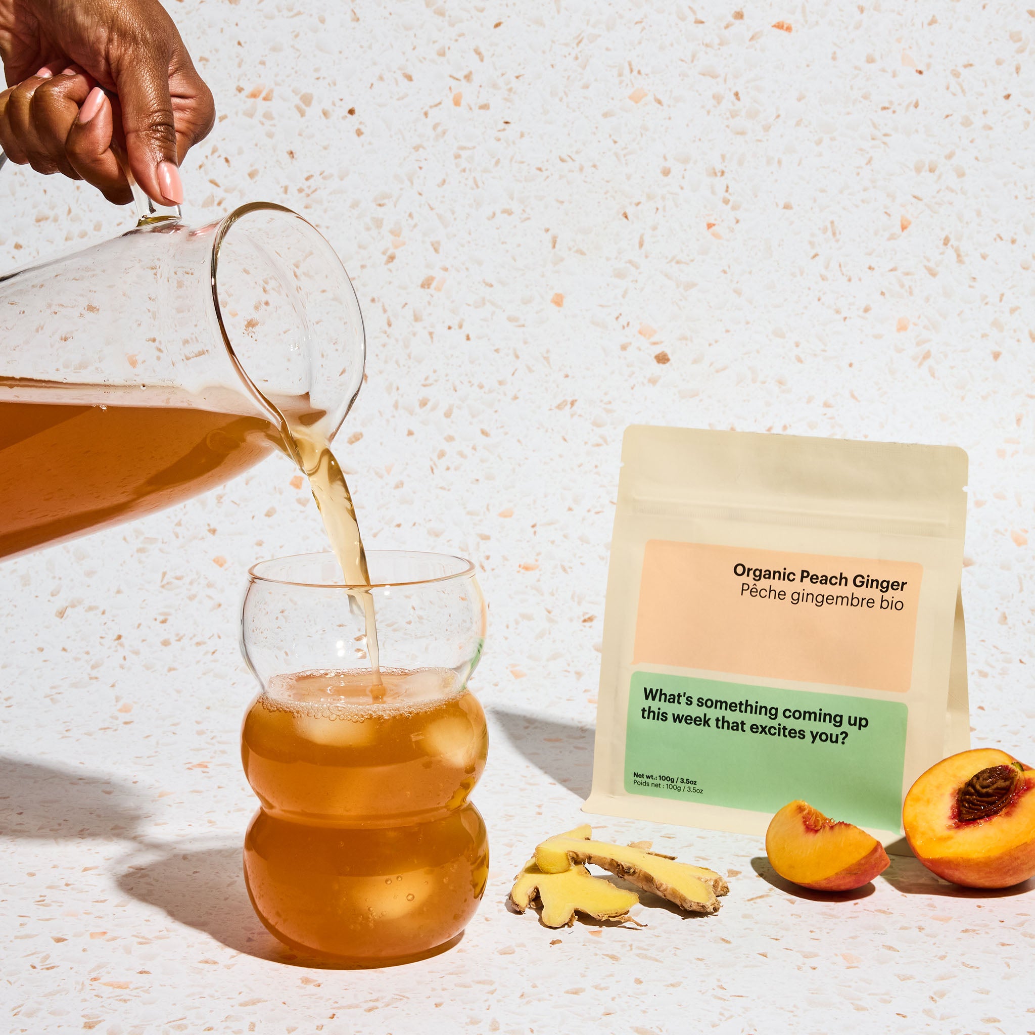 Organic peach ginger tea pouring from glass pitcher, iced tea, peaches and ginger, refreshing