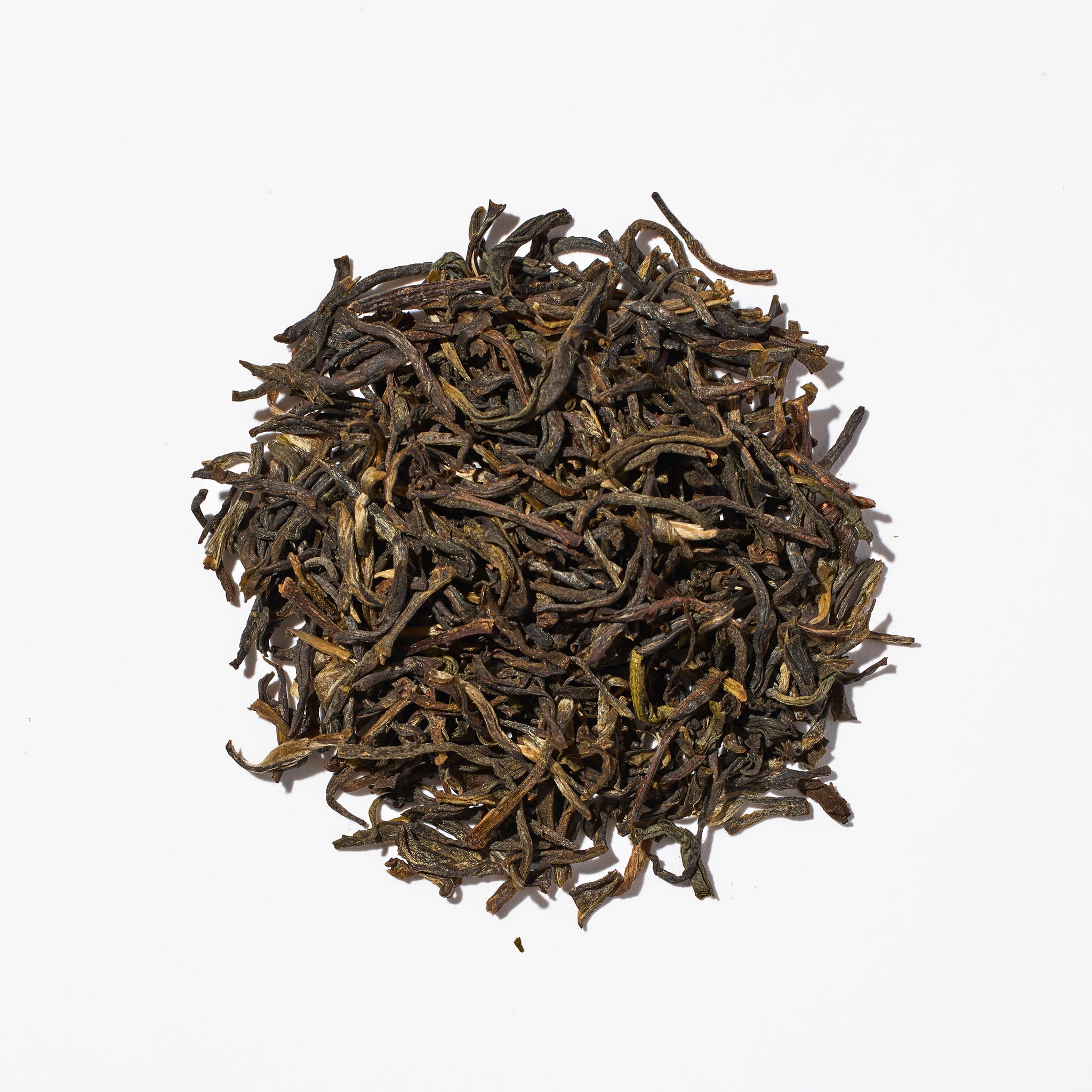 Macro close up of Organic Jasmine Green tea including details of premium organic green tea and jasmine blossoms
